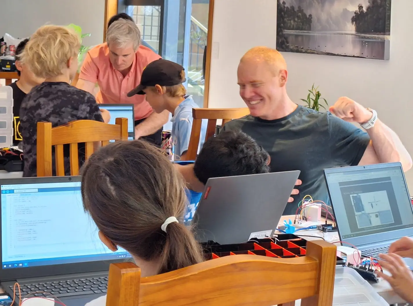 Students working with laptops, Arduino microcontrollers and electronic components